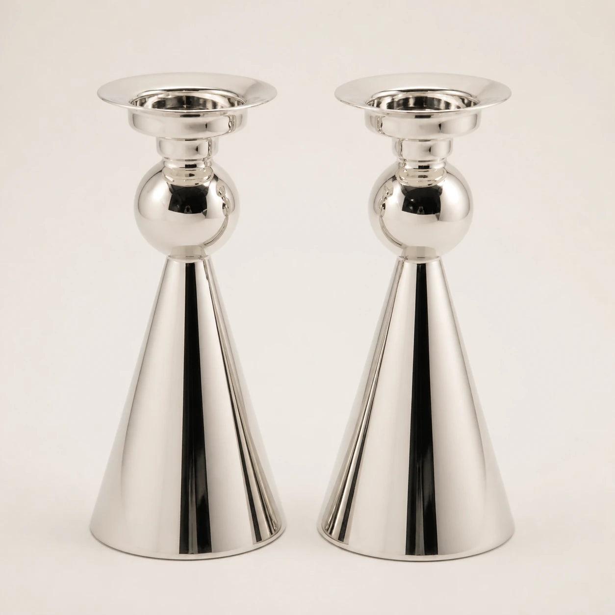 Pair of sculptural polished silver cone-form candlesticks