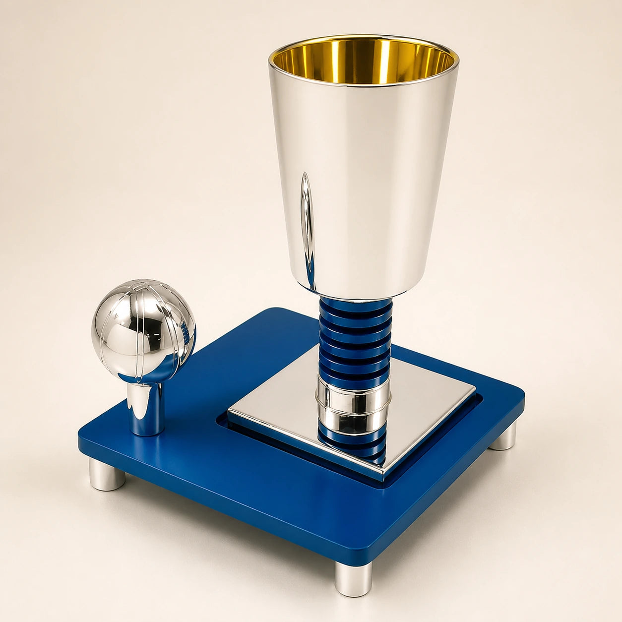 Polished silver ceremonial vessel on a cobalt-blue square base