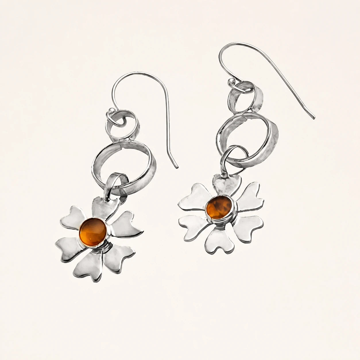 Pair of silver flower earrings with warm amber stones