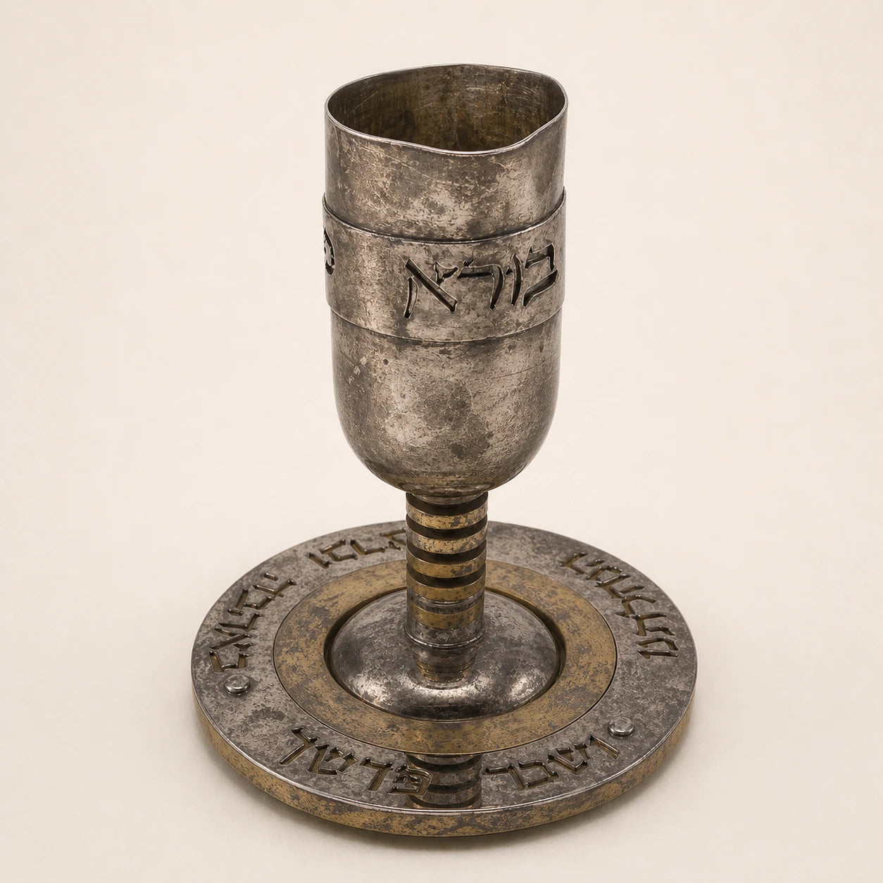 Illustrative heavily tarnished, dented and warped condition of Rafi Landau’s silver-and-gold Kiddush wine cup and plate