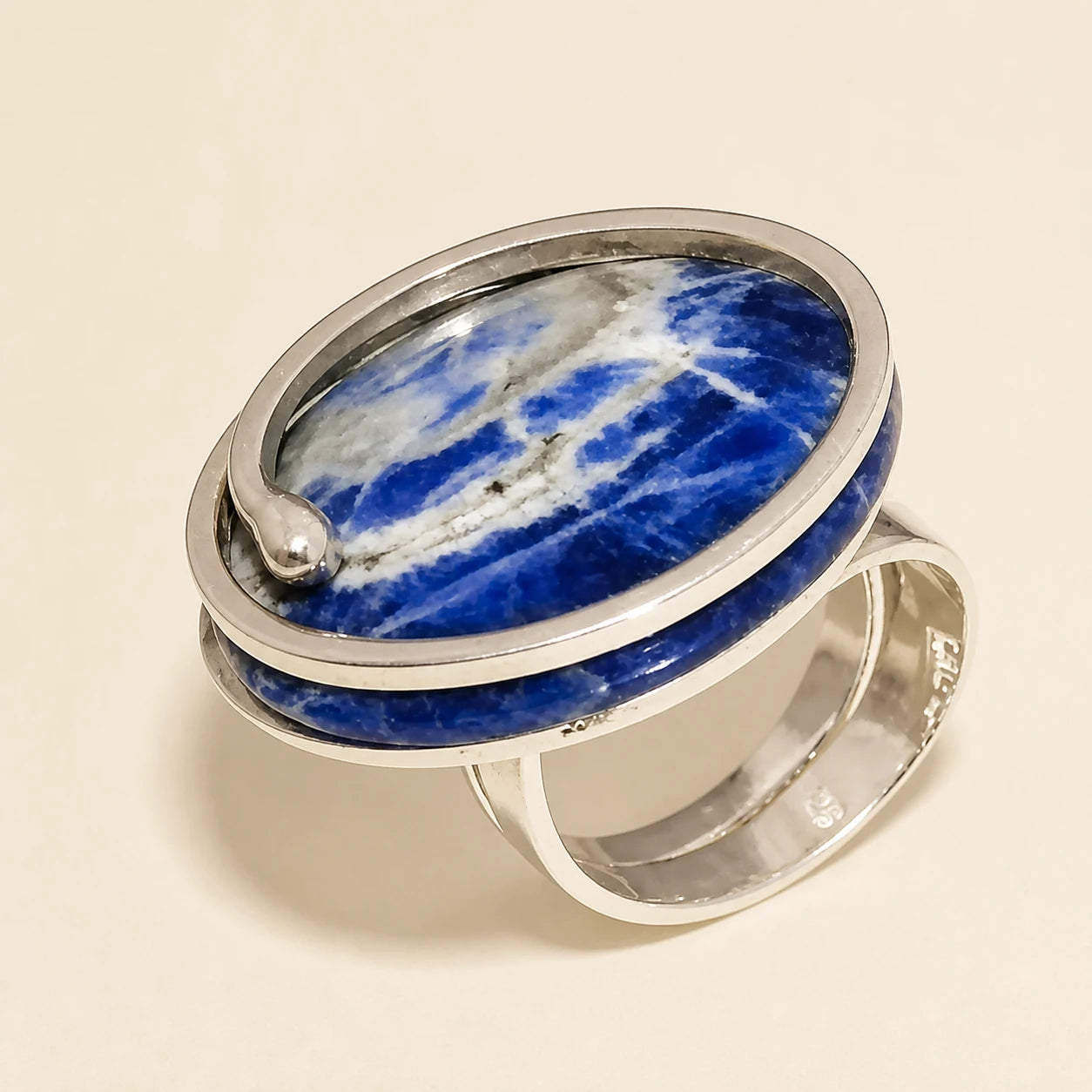 Sculptural silver ring with a large oval blue-and-white veined stone