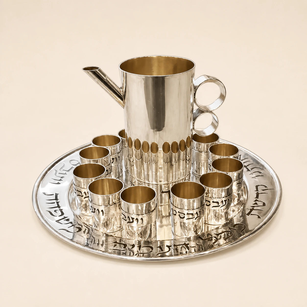 Silver ceremonial cup set arranged on a round tray